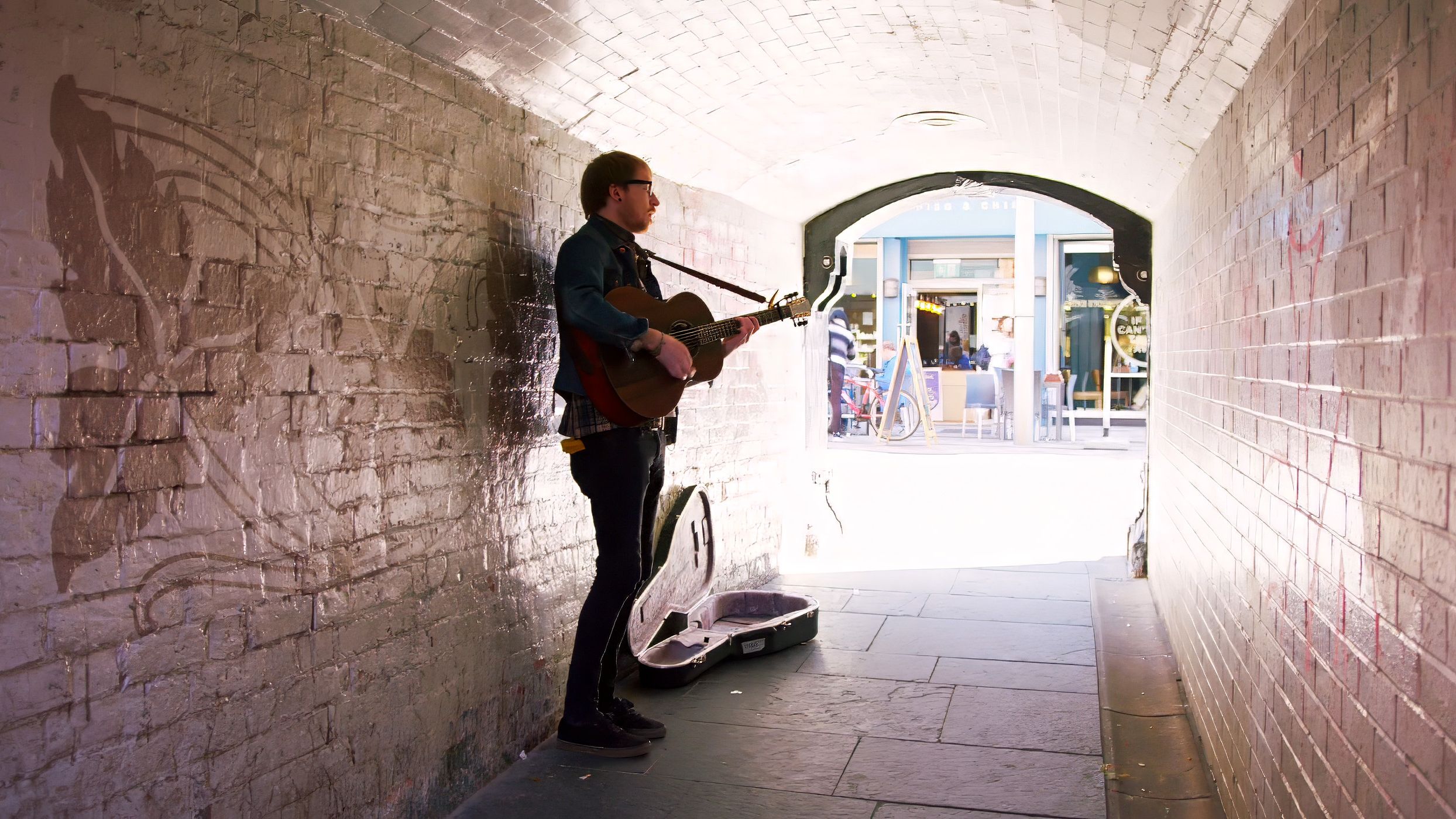 Guitarist performing in Pottinger’s Entry, Belfast, for the Belfast Is Ready tourism campaign